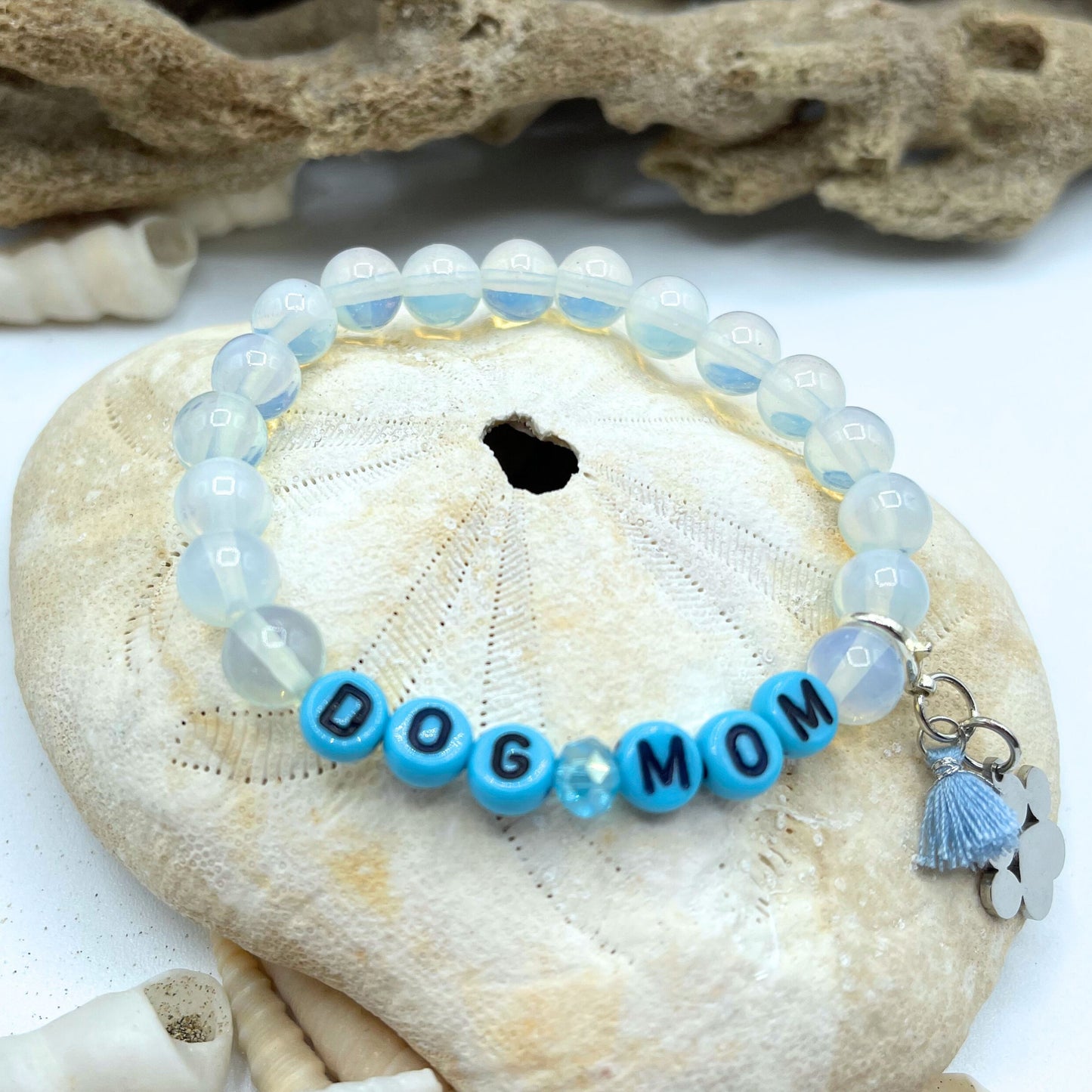 dog mom stretch bracelet made of moonstone beads and detachable paw and tassel charm